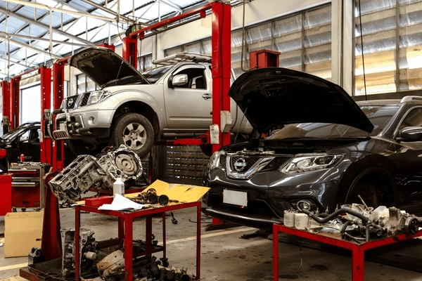 busy-car-repair-workshop-multiple-600nw-2467760913